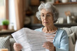 © Alexander - An elderly woman looks at the bills