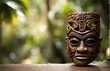 Wooden tiki mask of some tribu in the middle of a Tropical Forest