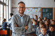 © LeoOrigami - Smiling male teacher in class looking at camera, students studying, Teachers' Day, Children's Day, primary school students, middle school students,rural teacher