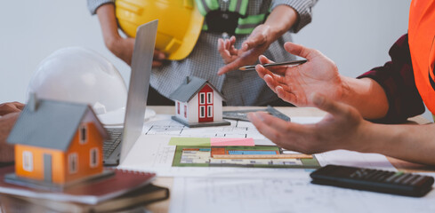 Wall Mural - Construction concept and teamwork meeting structure The engineer or architect for the project works with partners and engineering tools to create workplace models and blueprints.