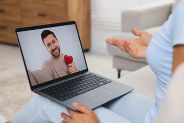 Canvas Print - Long distance love. Woman having video chat with her boyfriend via laptop at home, closeup