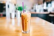closeup of iced chai latte in a tall glass with a straw