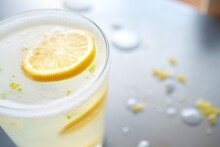 Closeup Of A Lemon Slice On The Rim Of A Soda Glass With Fizz