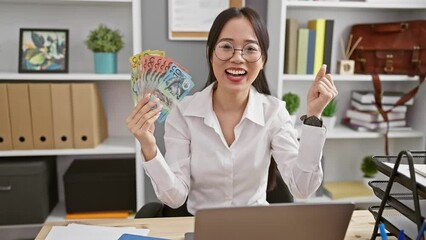 Sticker - Joyful young chinese woman celebrating win with australia dollars at office, exuding confident winner expression and radiant smile