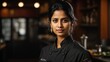© Ankor_stock. - chef or waiter middle age black haired  indian female  on uniform in dark background