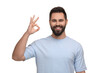 © New Africa - Man with clean teeth showing OK gesture on white background