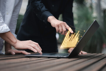 investment and finance concept, businessman holding virtual trading graph and blurred light on hand, stock market, profits and business growth.