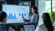 © CLOVER BACKGROUND - Young businesswoman presenting data analysis dashboard on TV screen in modern meeting. Business presentation with group of business people in conference room