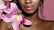 Decorative cosmetics. Close up beauty portrait of young African American model with pink lips make up posing with pink lily flowers.