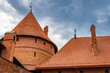 View of the red tiled roof and red brick masonry of the towers of Trakai Castle, Trakai, Lithuania