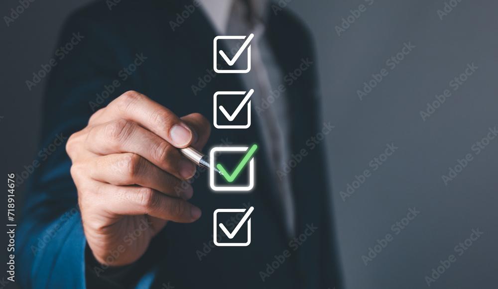 Checklist concept, business person checklist tick answer sign in checkbox, validation online questionnaire quality control document, man use pen to tick correct sign mark in checkbox form.