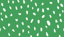 White Dots Of Irregular Shape And Different Sizes On A Green Background.