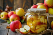 Canned apples. Jar with canned apples and fresh apples on wooden table	
