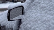 Close up of a car morror covered in snow