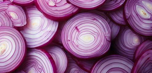 A close up of many onion slices. The onions are cut in half and arranged in a pattern
