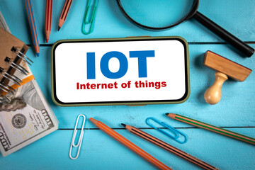 Wall Mural - IOT Internet of things Concept. Mobile phone on blue wooden table