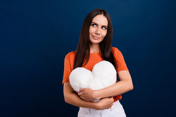 Sticker - Photo of stunning dreamy lady wear orange t-shirt cuddling soft white pillow looking empty space isolated dark blue color background