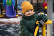 © alexkoral - happy child kid boy plays on the playground in the park in winter