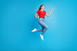 © deagreez - Photo of positive funky girl dressed trendy outfit walking summer vacation empty space isolated on blue color background