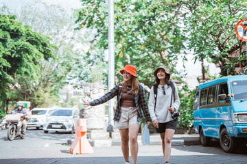 two local tourists enjoying a vacation walking on the sidewalk looking for tourist destinations