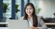 © Surachetsh - professionalism of a beautiful girl works diligently in her office, focused in front of her laptop. Generative AI.