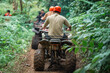 © Odua Images - the back of asian man that riding the atv through the atv track at amusement park together with his partner
