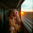 Girl listening to music on train watching sunset