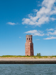 Wall Mural - Former church tower Plompetoren on dike at Oosterschelde, Easter Scheldt, estuary, Zeeland, Netherlands