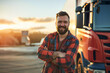 Portrait of a smiling truck driver. A happy confident driver stands in front of his truck