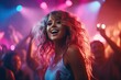 Charming curly young woman in a colorful singlet having fun in a nightclub under neon lights among dancing people