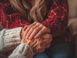 © mnirat - A heartwarming photo of a young woman gently holding the hand of an elderly person