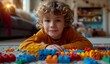 © olegganko - young boy playing with building blocks