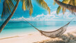 A hammock hanging from some palm trees on the beach