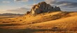 Dramatic golden light and shadow on the rock in autumn steppe.
