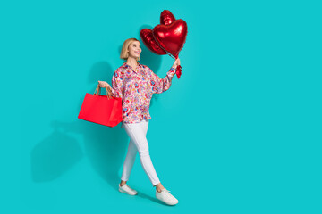 Sticker - Full size photo of attractive young woman shopping bags heart balloons wear trendy pink print clothes isolated on cyan color background