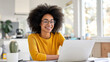 © Black AI - Woman Sitting in Front of Laptop Computer for Work and Productivity. Generative AI.