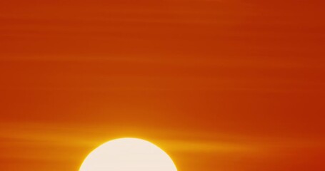 Wall Mural - Big sun Timelapse Sunrise, close up of big sun rising through clouds. Beautiful nature background time laps.