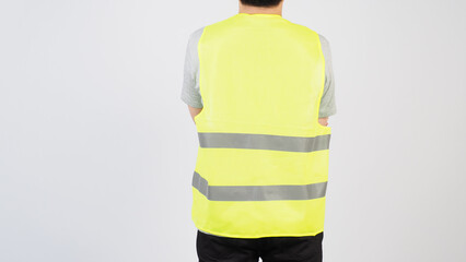 Man wear Safety Vest and turn back on white background.