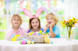 © famveldman - Kids on Easter egg hunt. Children dye eggs.