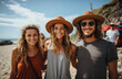 © LifeMedia - A group of stylish vacationers bask in the warm sun, showcasing their fun and fashionable accessories while posing for a picture on the sandy beach