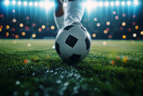 Fototapeta Sport - Close up of football player leg action in running game at football stadium arena for match with spotlight. Soccer sport background, green grass field.