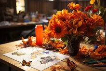 Bright Orange Flowers And Illustrated Butterflies Create An Artistic And Warm Composition On A Table