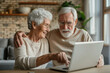 Happy family at the laptop computer. Smiling elderly senior man and woman, husband and wife
