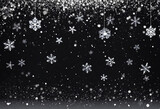 Fototapeta Na sufit - Snowflakes falling against a black sky with bokeh effect.