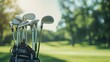 Golf bag and clubs in front of a blurred golf course background