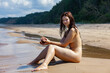 © misu - Naked woman sunbathing on the beach, enjoying nature and solitude