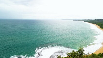 Wall Mural - High altitude pan from ocean over beach to vibrant jungle of Bocas Del Toro in Panama