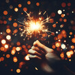 © Honeys - Woman hand holding a burning sparkler. Christmas and new year sparkler holiday background. Play Fireworks New Year's Eve. diwali . sparklers hand. diwali sparklers.