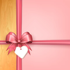 Wall Mural - Template of 3d pink bow with crisscross silk ribbons and heart label tag on pink background with golden frame. Cute bow with crossed tapes as gift box wrap or greeting card with empty place for text