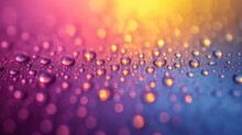  A Close Up Of Water Droplets On A Purple And Blue Surface With A Yellow And Pink Background In The Center Of The Image Is A Blurry Blurry Image.